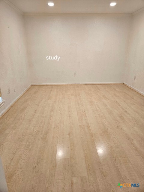 empty room featuring recessed lighting, light wood-style floors, baseboards, and ornamental molding