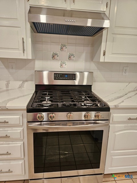 kitchen with tasteful backsplash, white cabinetry, stainless steel range with gas cooktop, and under cabinet range hood