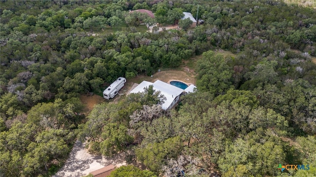 birds eye view of property with a wooded view