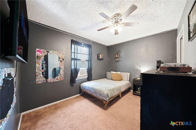 carpeted bedroom with a textured ceiling and ceiling fan