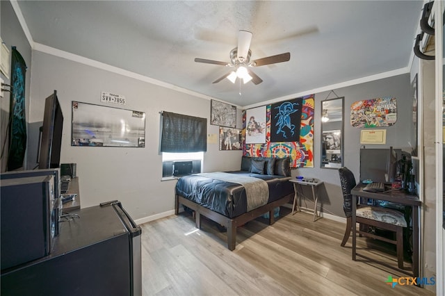 bedroom featuring crown molding, baseboards, and light wood-style flooring