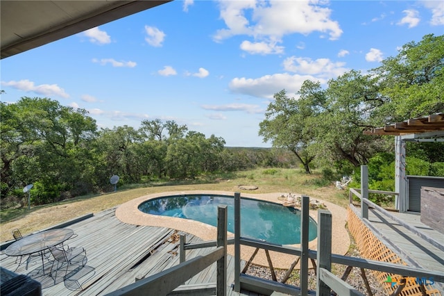 outdoor pool with a wooden deck