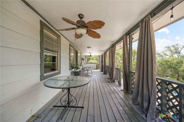 unfurnished sunroom featuring a ceiling fan and a wealth of natural light