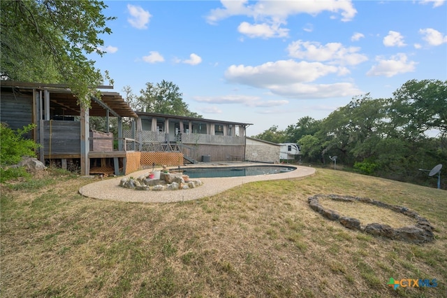 view of yard with an outdoor pool and a deck