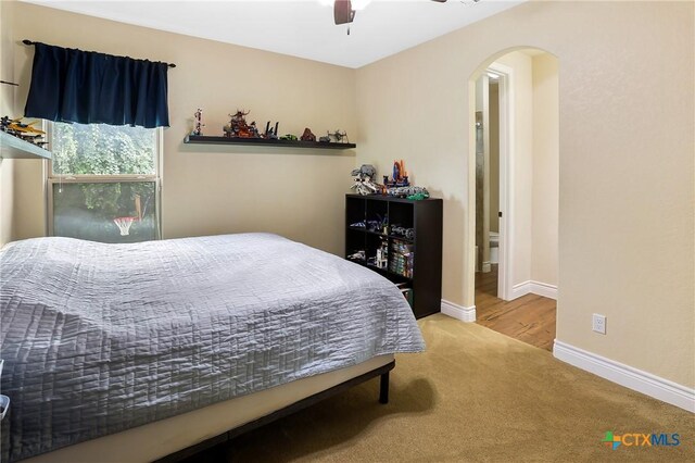 335 Mill Run, New Braunfels, TX 78132 - bedroom featuring arched walkways, carpet, and a ceiling fan