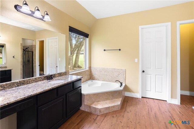 335 Mill Run, New Braunfels, TX 78132 - full bathroom featuring vanity, a stall shower, wood finished floors, and a bath