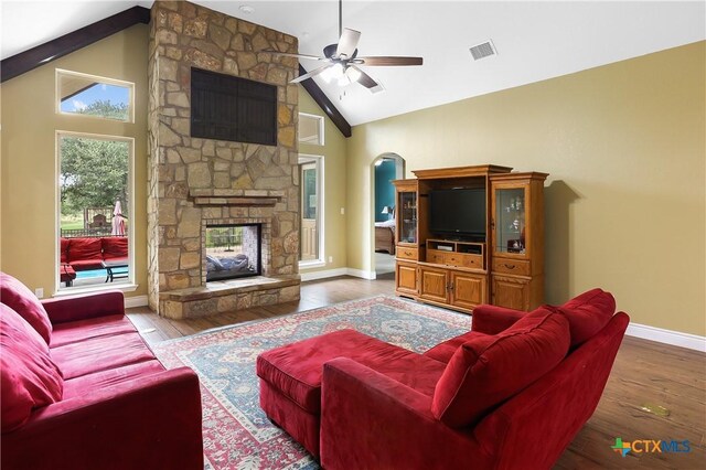 335 Mill Run, New Braunfels, TX 78132 - living room featuring a ceiling fan, a fireplace, wood finished floors, arched walkways, and high vaulted ceiling