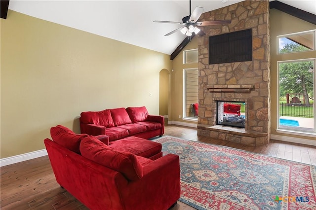 335 Mill Run, New Braunfels, TX 78132 - living room featuring a fireplace, wood-type flooring, arched walkways, high vaulted ceiling, and a ceiling fan
