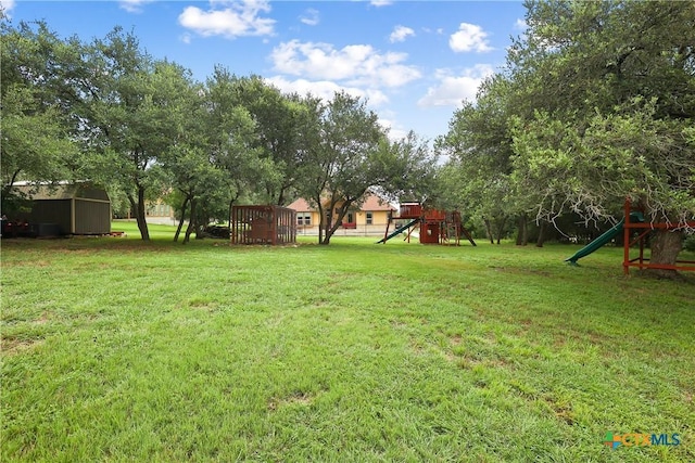 335 Mill Run, New Braunfels, TX 78132 - view of grassy yard featuring a playground and a shed