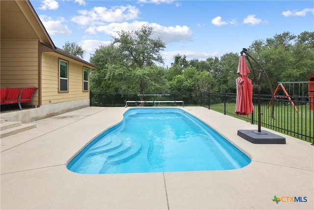 335 Mill Run, New Braunfels, TX 78132 - view of swimming pool with a patio, a fenced backyard, view of scattered trees, and a playground