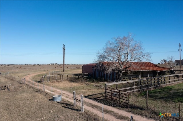 view of yard featuring an outbuilding and a rural view