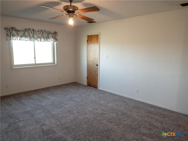 spare room featuring ceiling fan, a textured ceiling, and carpet flooring