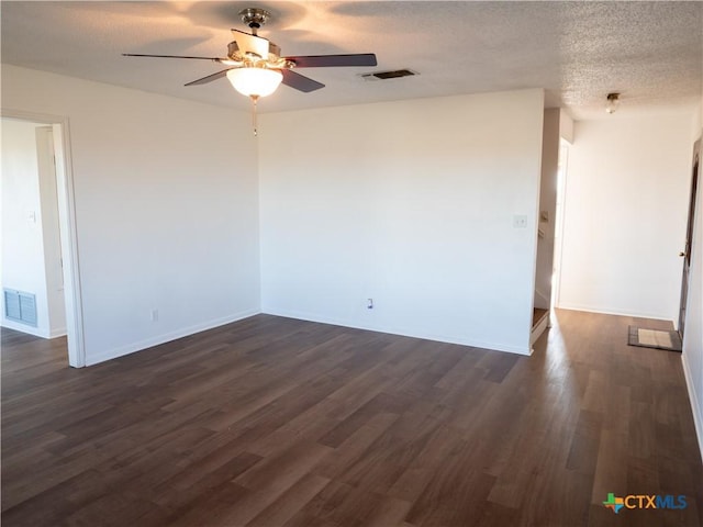 unfurnished room with ceiling fan, dark wood-type flooring, and a textured ceiling