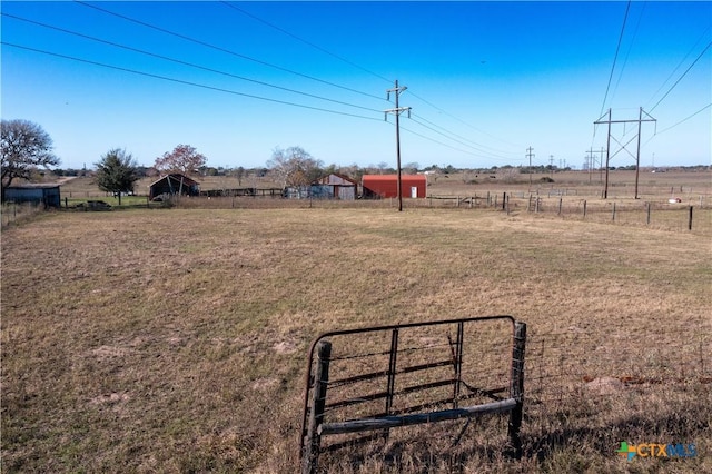 view of yard with a rural view