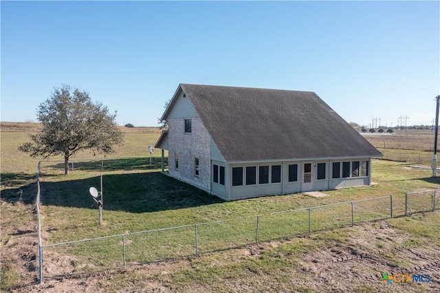 exterior space with a yard and a rural view