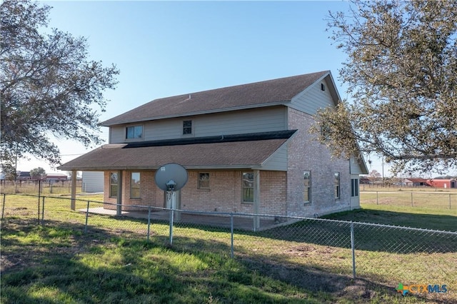 back of house with a yard