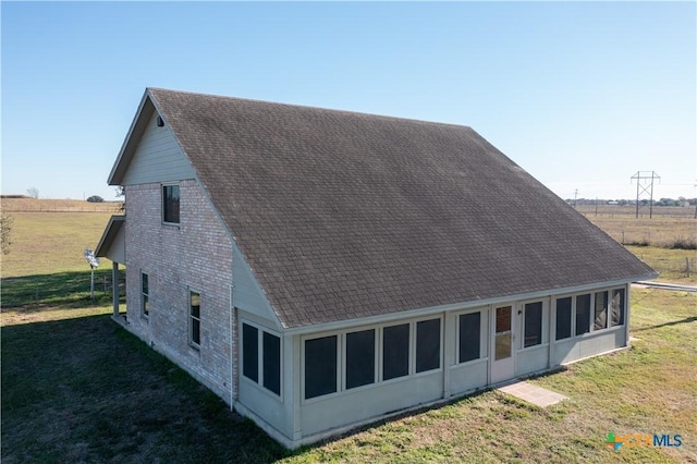 view of side of home with a yard