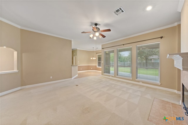 unfurnished living room with ceiling fan, light carpet, crown molding, and a fireplace