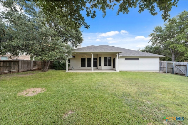 back of property featuring a yard and a patio area