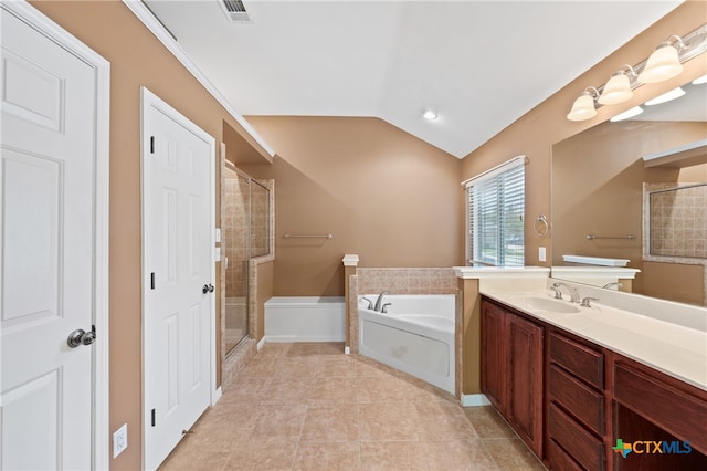 bathroom with tile patterned flooring, vanity, plus walk in shower, and vaulted ceiling