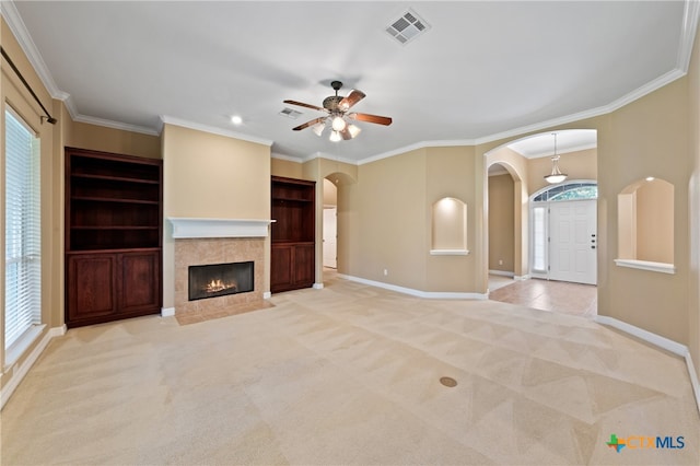 unfurnished living room featuring light colored carpet, ceiling fan, and crown molding