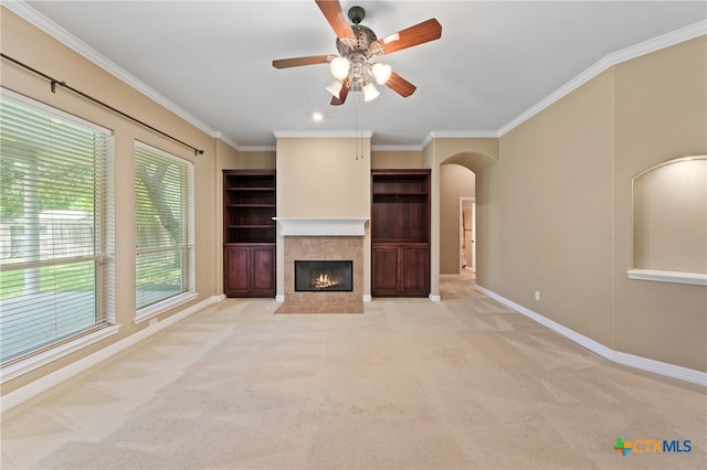 unfurnished living room with a fireplace, light carpet, and crown molding