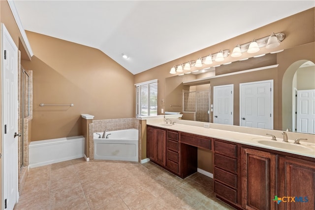 bathroom featuring vanity, independent shower and bath, tile patterned floors, and lofted ceiling