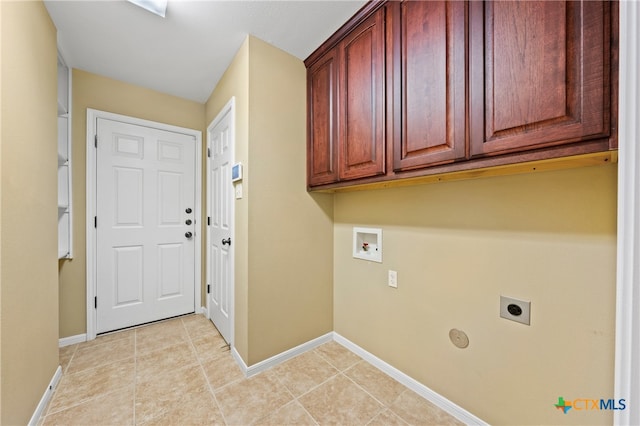 laundry room featuring light tile patterned floors, electric dryer hookup, cabinets, and washer hookup