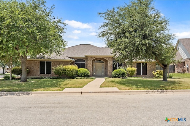 ranch-style house with a front lawn