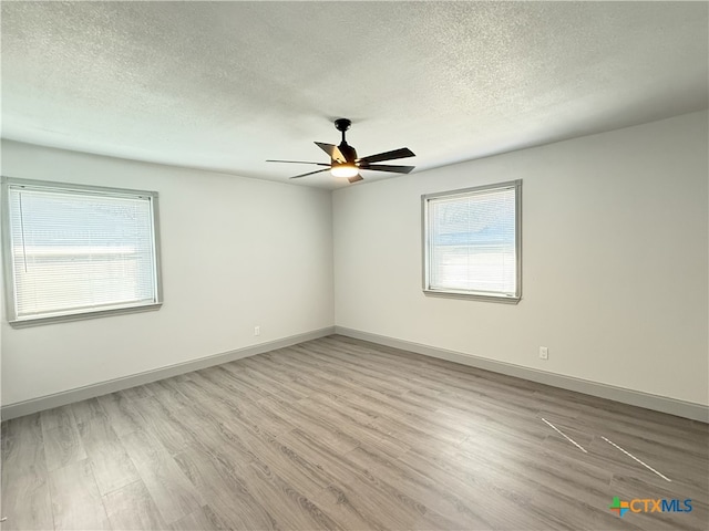 unfurnished room featuring ceiling fan, a textured ceiling, and light hardwood / wood-style floors