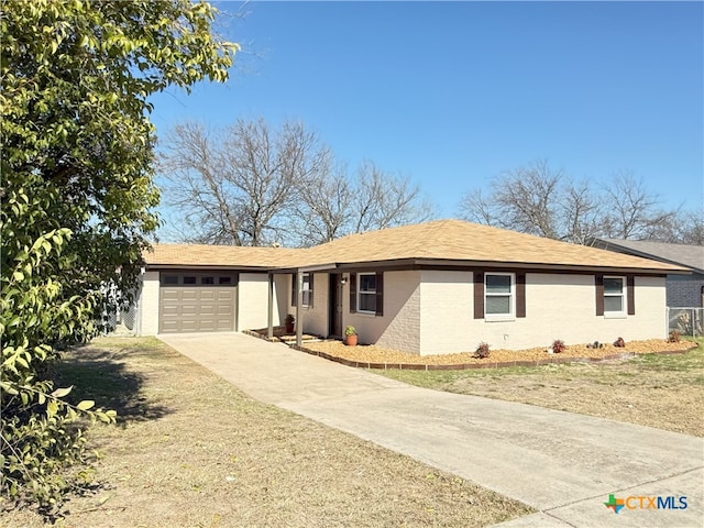 ranch-style home with a garage and a front yard