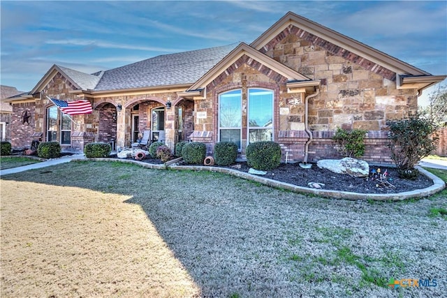 view of front of house with a porch and a front lawn