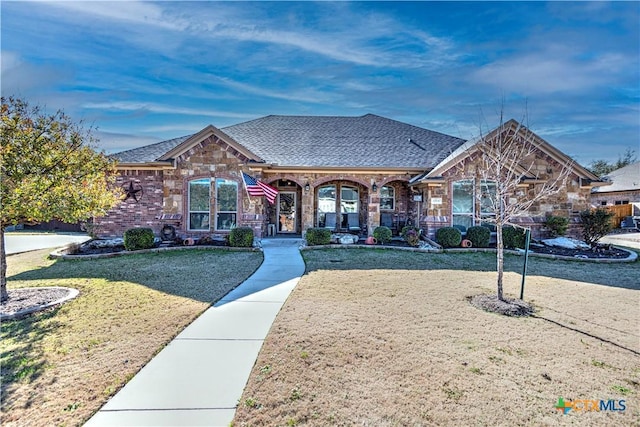 view of front of house with covered porch and a front lawn