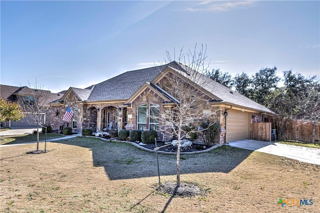 view of front of home with a garage and a front yard