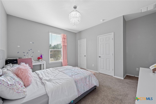 bedroom with carpet and a notable chandelier