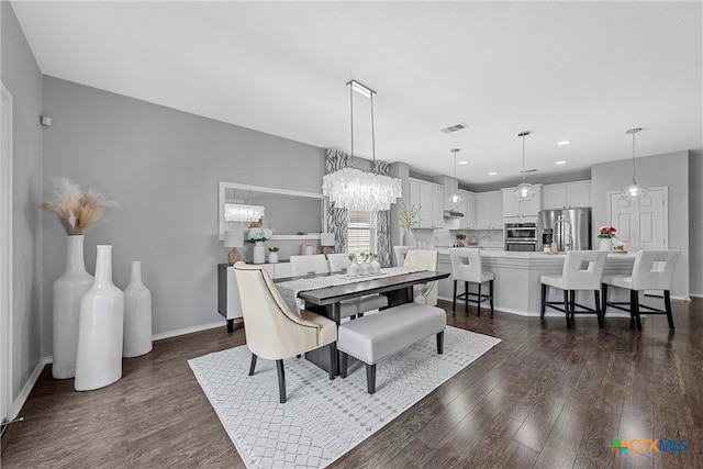 dining room featuring dark wood-type flooring and a notable chandelier