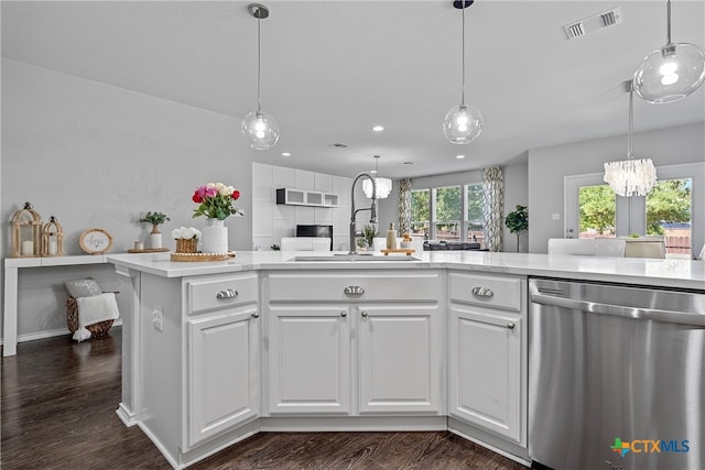 kitchen with white cabinetry, dark hardwood / wood-style flooring, stainless steel dishwasher, and an inviting chandelier