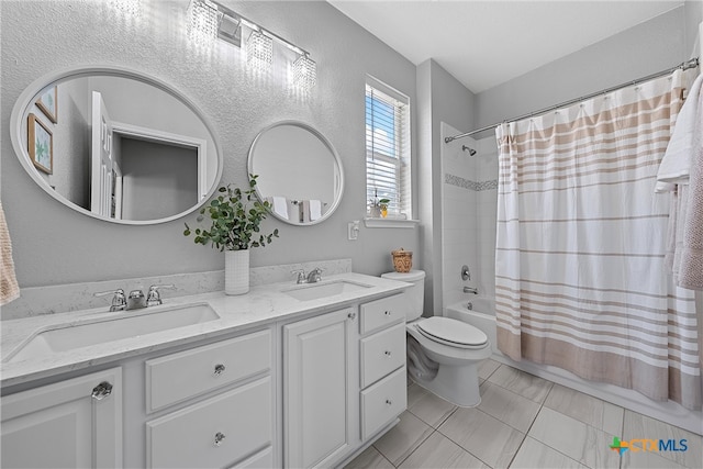 full bathroom featuring toilet, vanity, shower / bath combo with shower curtain, and tile patterned flooring