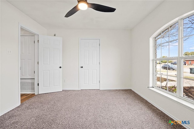 unfurnished bedroom with ceiling fan and carpet