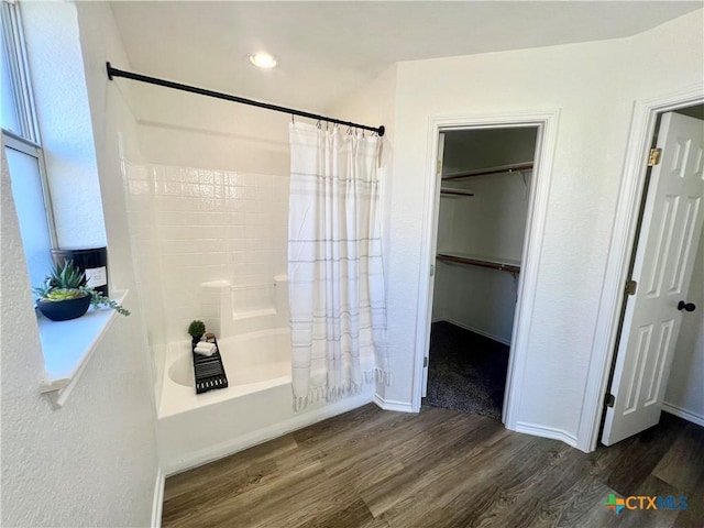 bathroom featuring wood-type flooring and shower / bath combo