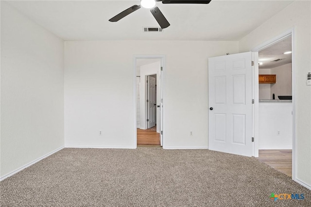 unfurnished bedroom featuring ceiling fan and carpet flooring