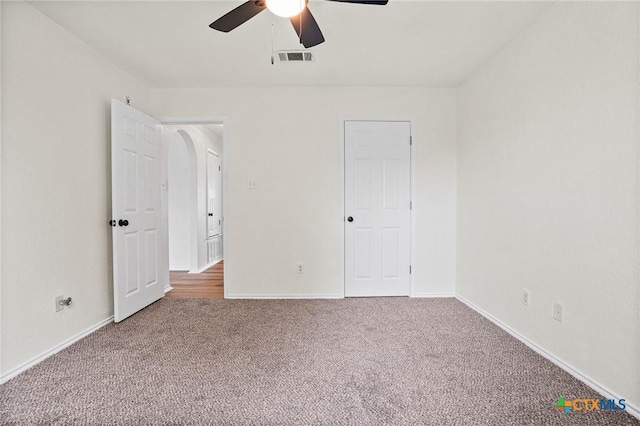 unfurnished bedroom featuring ceiling fan and carpet floors