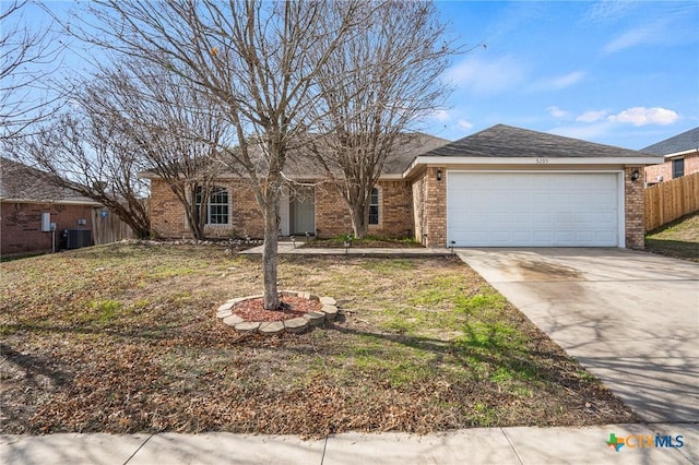 single story home featuring a garage and a front lawn