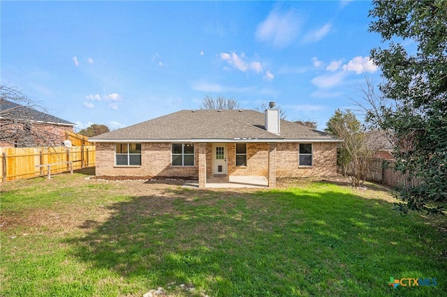 rear view of house with a patio and a yard