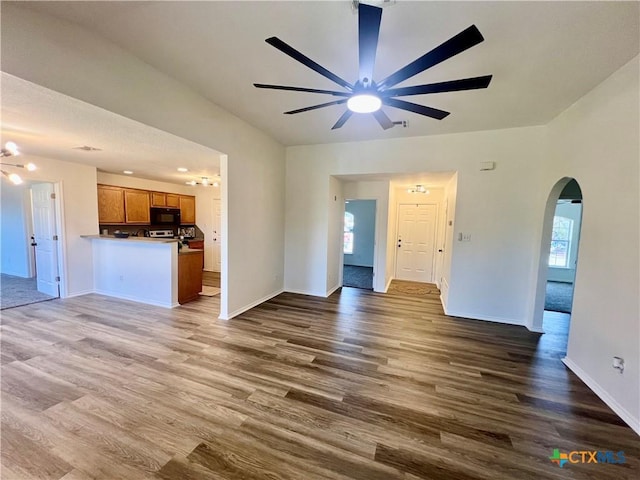 unfurnished living room with hardwood / wood-style flooring and ceiling fan