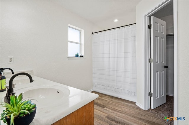 bathroom with vanity and hardwood / wood-style flooring