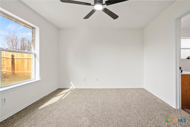 spare room featuring carpet flooring and ceiling fan