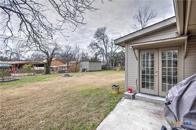 view of yard featuring a patio area and french doors