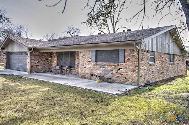 single story home featuring a garage, a patio area, and a front yard