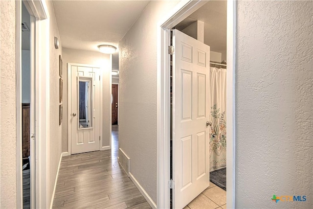 corridor featuring light hardwood / wood-style flooring